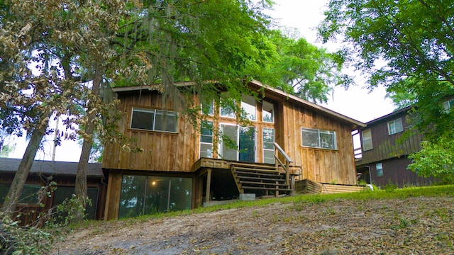 12 Walker Trl, Huntsville, TX 77320 - view of front of home with a deck and board and batten siding