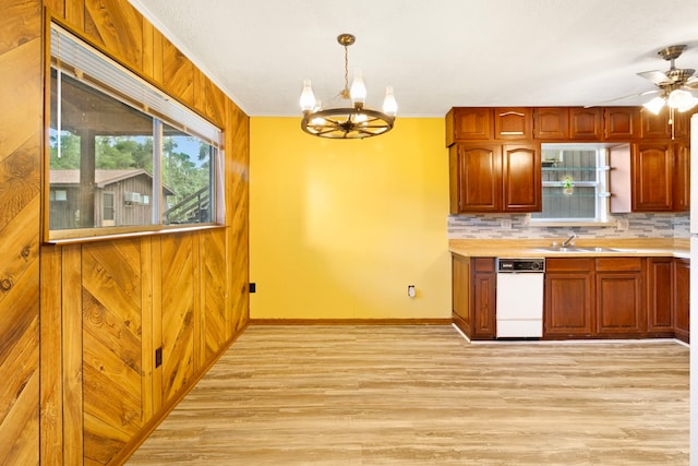 12 Walker Trl, Huntsville, TX 77320 - kitchen featuring light wood-type flooring, a chandelier, baseboards, a sink, and light countertops