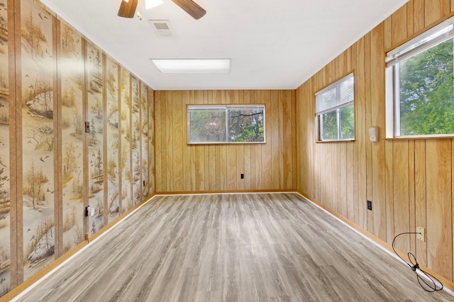 12 Walker Trl, Huntsville, TX 77320 - spare room featuring wood finished floors, healthy amount of natural light, ceiling fan, wooden walls, and baseboards