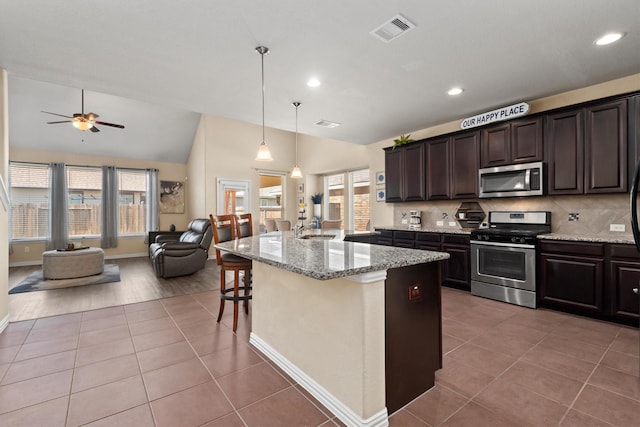 kitchen featuring visible vents, appliances with stainless steel finishes, open floor plan, and tile patterned floors