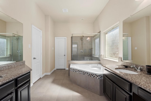 full bath featuring a bath, tile patterned floors, a sink, and a shower stall