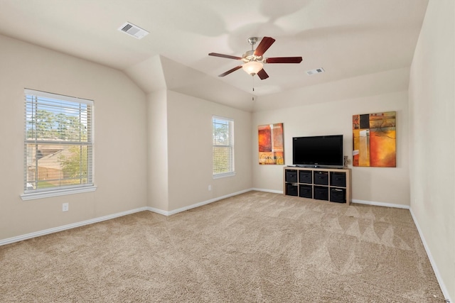 unfurnished living room featuring plenty of natural light, visible vents, and carpet floors