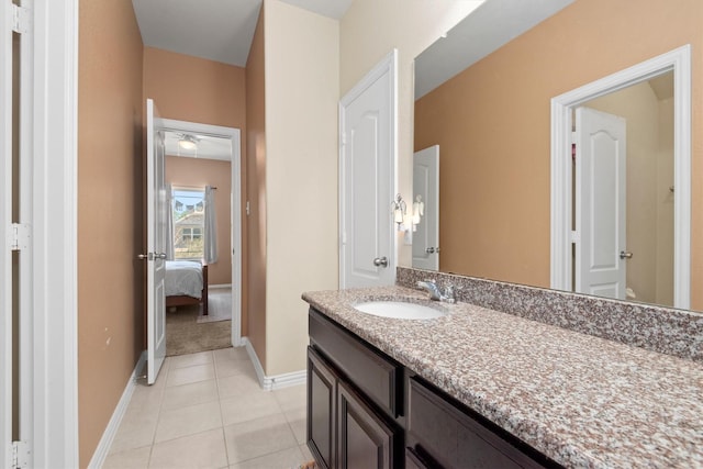 bathroom with baseboards, tile patterned flooring, and vanity