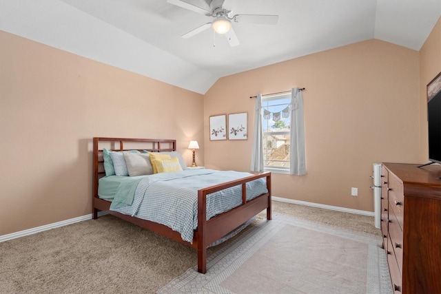 carpeted bedroom featuring ceiling fan, vaulted ceiling, and baseboards