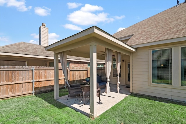 view of patio featuring a ceiling fan and fence