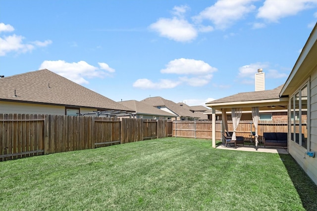 view of yard with outdoor lounge area, a fenced backyard, and a patio