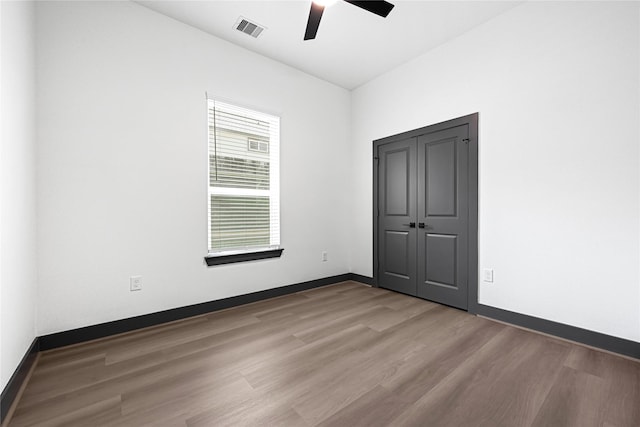 7038 Smilax St A-B, Unit A-B Houston, TX 77088 - unfurnished bedroom with wood finished floors, baseboards, and ceiling fan