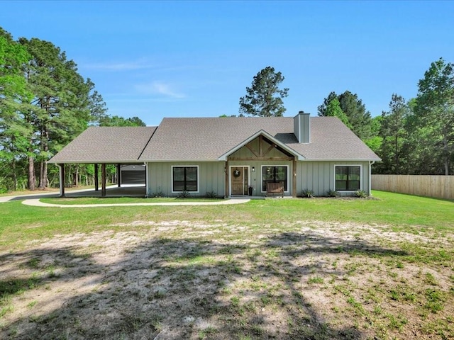 ranch-style home with a chimney, a front lawn, and fence