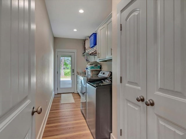 washroom featuring light wood-style flooring, baseboards, recessed lighting, cabinet space, and washer and dryer