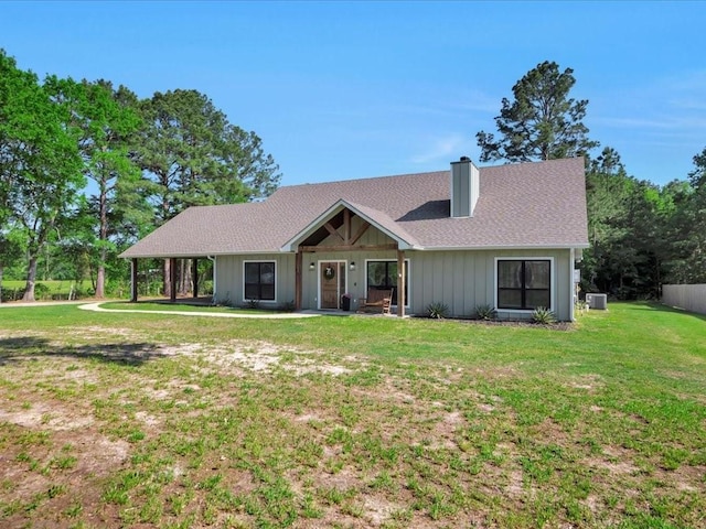 single story home with a front lawn, a chimney, and central AC