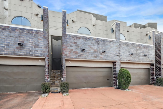exterior space featuring concrete driveway and a garage