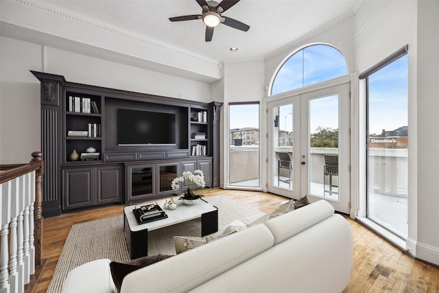 living area featuring ceiling fan, crown molding, french doors, and light wood finished floors