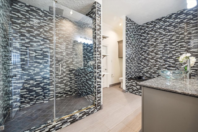 full bath with a shower stall, toilet, and vanity