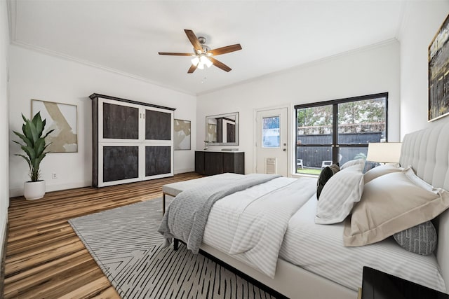 bedroom with crown molding, wood finished floors, ceiling fan, baseboards, and access to outside