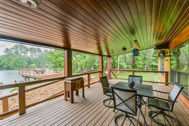 wooden deck featuring a water view and outdoor dining space