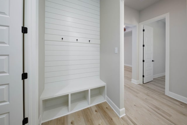 mudroom featuring light wood-style flooring and baseboards