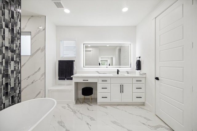 bathroom featuring visible vents, vanity, marble finish floor, recessed lighting, and a freestanding bath