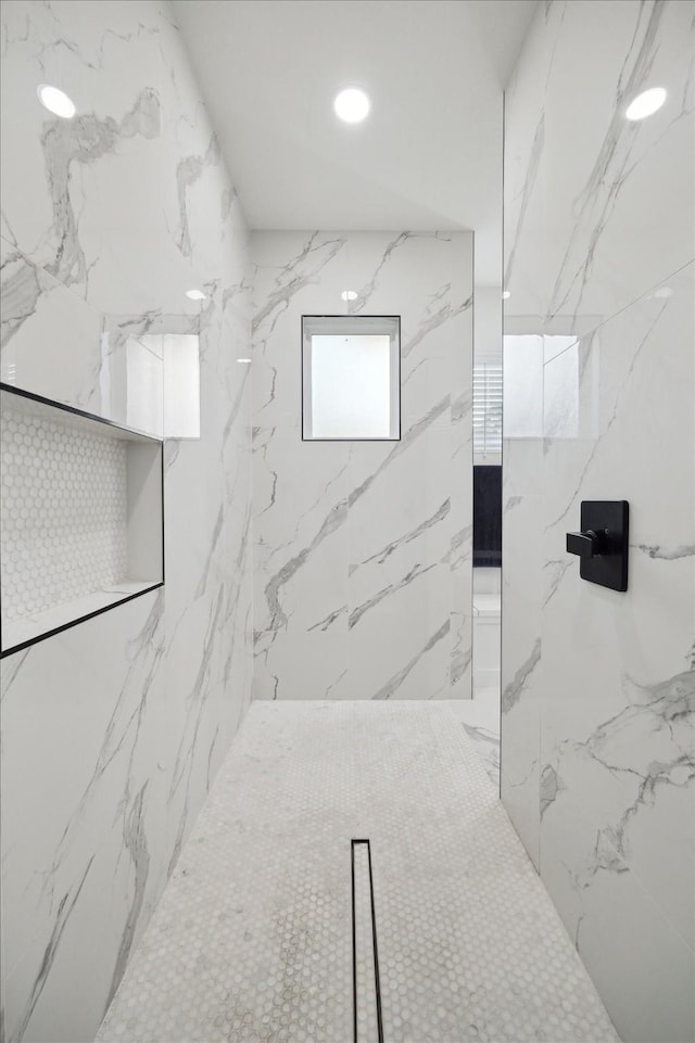 full bathroom featuring a marble finish shower