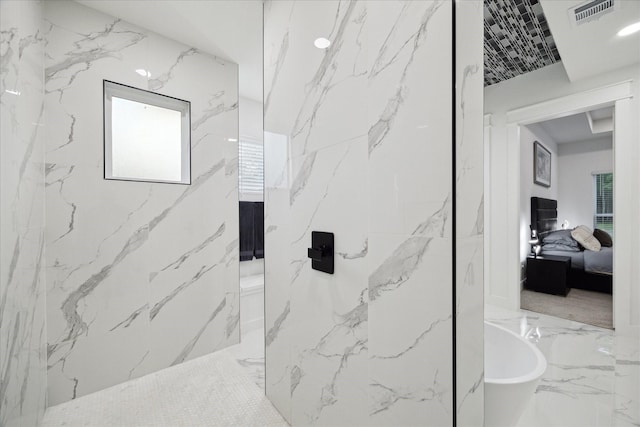 ensuite bathroom with visible vents, marble finish floor, a freestanding tub, and connected bathroom