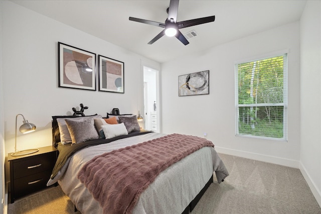 carpeted bedroom featuring visible vents, baseboards, and ceiling fan
