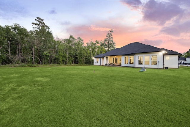 rear view of property with a yard