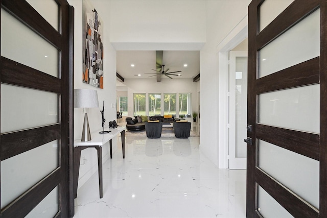 foyer featuring ceiling fan, recessed lighting, and marble finish floor
