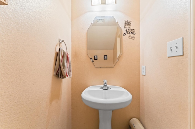bathroom with a textured wall