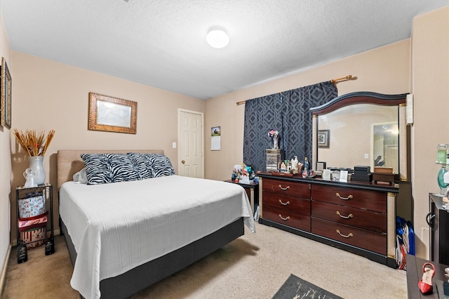 bedroom with a textured ceiling and light carpet
