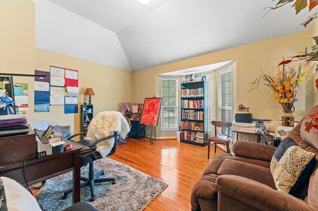 office with vaulted ceiling and wood finished floors