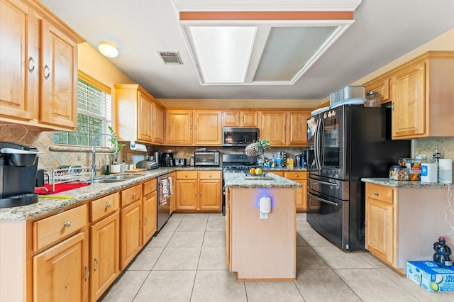 kitchen featuring light stone countertops, a sink, stainless steel appliances, decorative backsplash, and visible vents