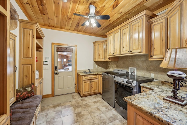 laundry room with a sink, independent washer and dryer, ceiling fan, cabinet space, and wood ceiling