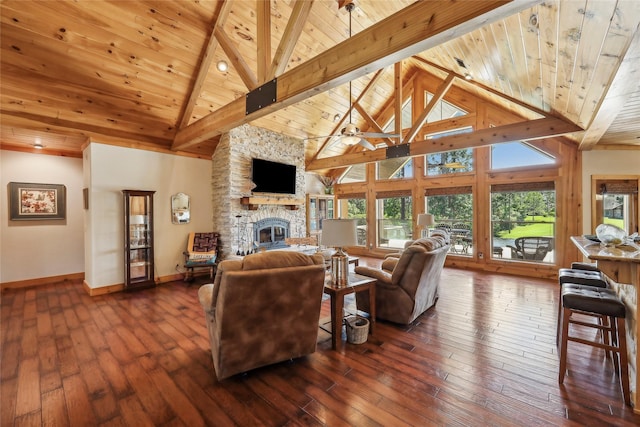 living area featuring wood ceiling, a stone fireplace, and high vaulted ceiling