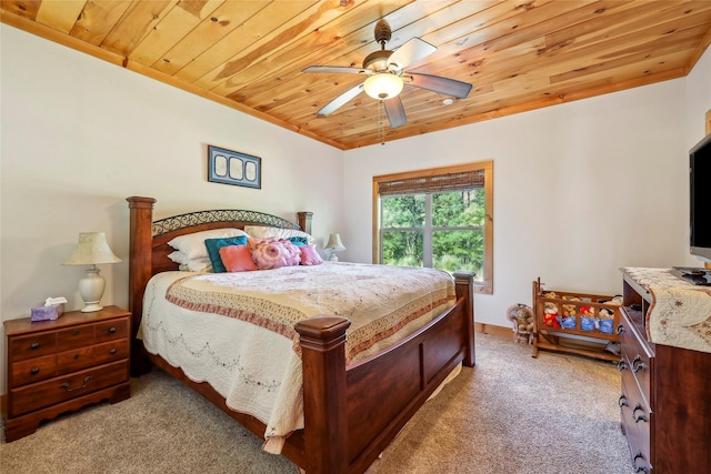 carpeted bedroom with wood ceiling, a ceiling fan, and crown molding