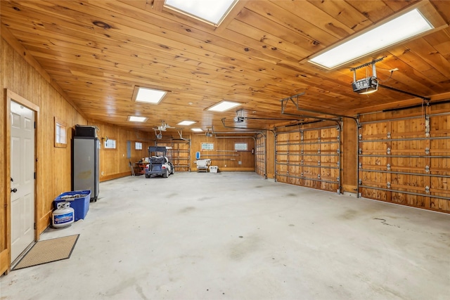 garage with wooden walls and a garage door opener
