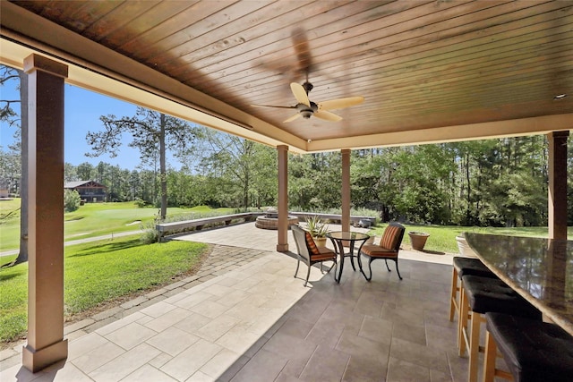 view of patio / terrace featuring a ceiling fan, golf course view, and outdoor dining area