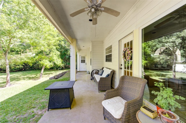 view of patio featuring an outdoor fire pit and ceiling fan