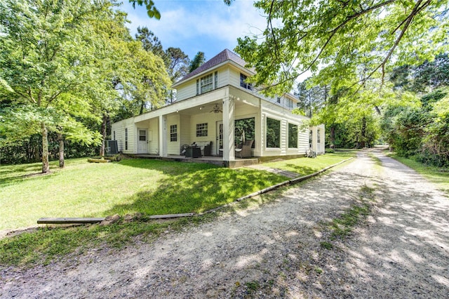 rear view of property featuring central AC, a yard, a patio, and ceiling fan