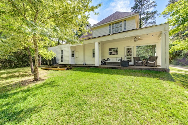rear view of house with a lawn, an outdoor living space, a ceiling fan, and a patio