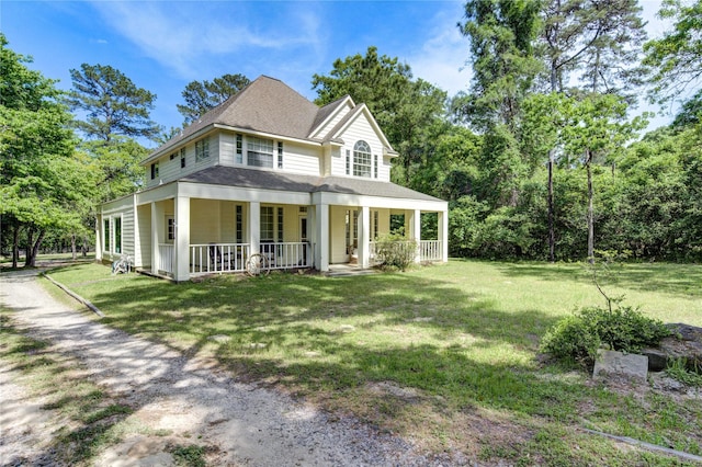 country-style home featuring a front lawn, a porch, and a shingled roof