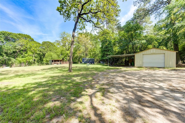 view of yard with a garage and an outdoor structure