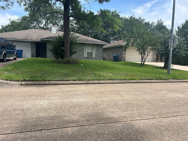 7810 Sawmill Trl, Houston, TX 77040 - view of front of property with a garage, driveway, a chimney, and a front yard