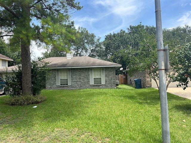 7810 Sawmill Trl, Houston, TX 77040 - view of home's exterior with a lawn and a chimney