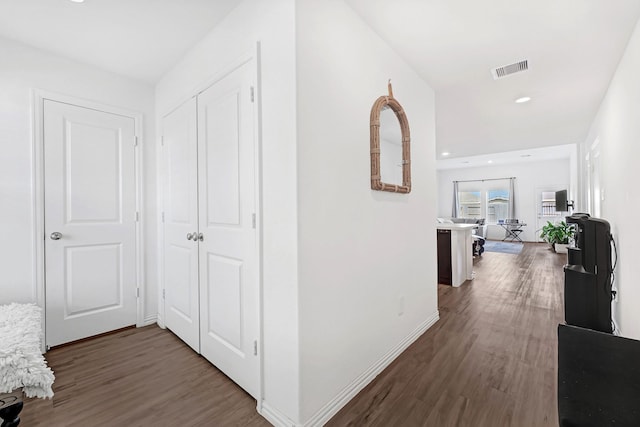 hallway featuring recessed lighting, wood finished floors, visible vents, and baseboards