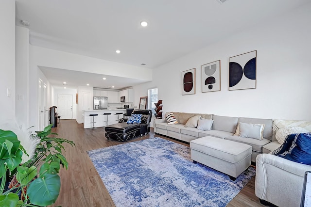 living area with recessed lighting and dark wood finished floors
