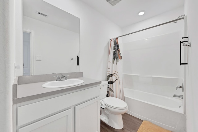 bathroom featuring wood finished floors, visible vents, toilet, vanity, and shower / bath combo