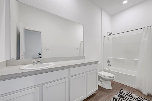 bathroom with recessed lighting, shower / bath combination with curtain, wood finished floors, toilet, and vanity