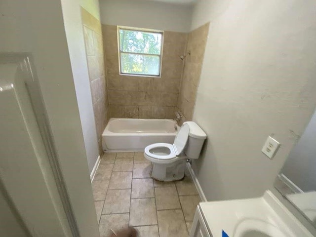 bathroom featuring tile patterned floors, washtub / shower combination, vanity, and toilet