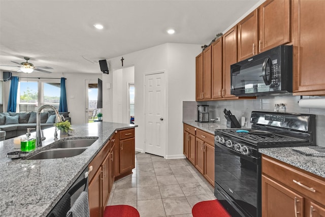 kitchen featuring brown cabinetry, ceiling fan, a sink, and black appliances