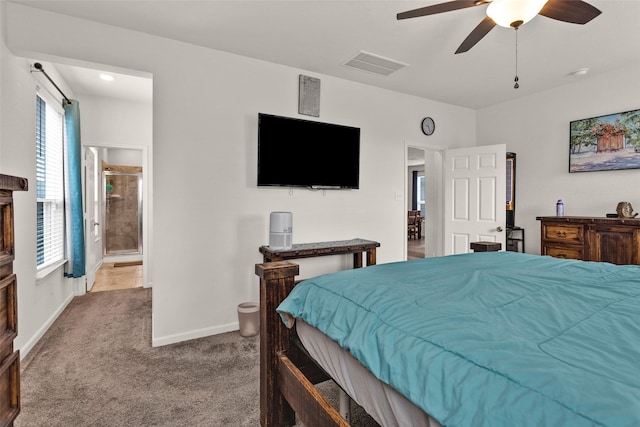 carpeted bedroom with connected bathroom, ceiling fan, baseboards, and visible vents
