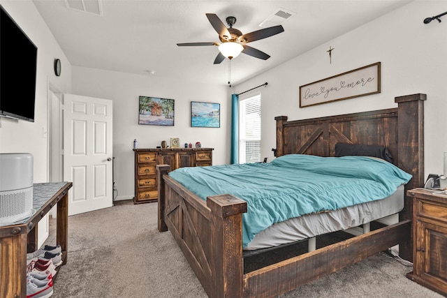 carpeted bedroom with ceiling fan and visible vents
